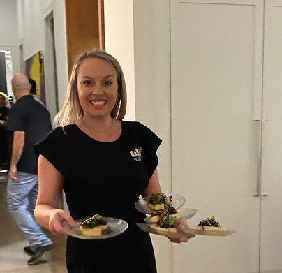 ISLE Bartend team member serving guests at an event bar