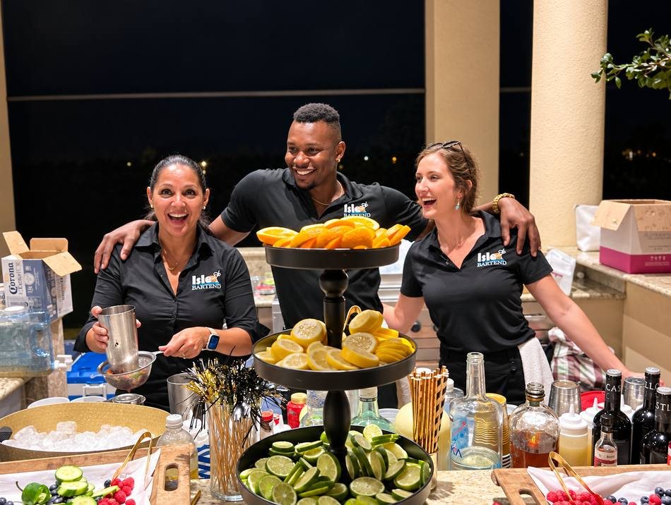 ISLE Bartend team member serving guests at an event bar