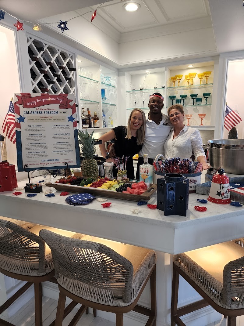 ISLE Bartend team at a 4th of July Calabrese Freedom celebration bar with flags and fresh fruit