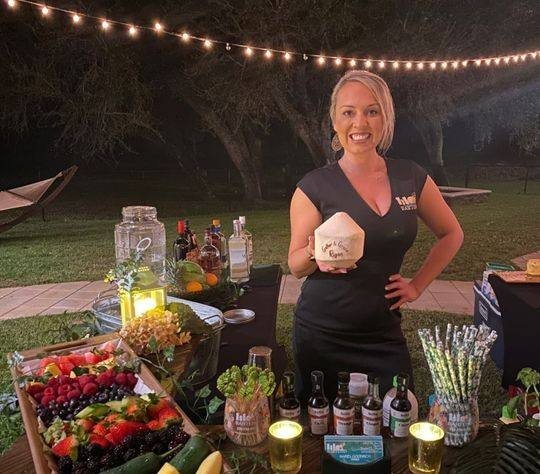 ISLE Bartend team member serving guests at an event bar